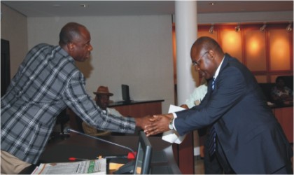 Rivers State Governor, Rt. Hon. Chibuike Rotimi Amaechi (left) congratulating Dr Tekena Ibanibo after being sworn-in as Permanent Secretary in the State Civil Service at Government House, Port Harcourt, yesterday.