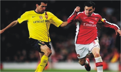 Arsenal’s Cesc Fabregas (right) and Sergio Busquets of Barcelona. Both are expected to clash in midfield  today