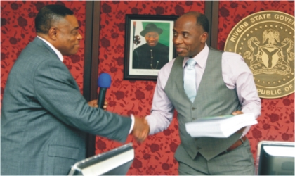 Rivers State Governor, Rt. Hon. Chibuike Amaechi (right) receiving a report from the Chairman, Rivers State Independent Electoral Commission (RSIEC), Prof. Nimi Briggs during the commission’s presentation of end of tenure report at Government House, Port Harcourt, yesterday.