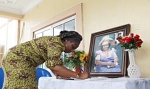 Wife of the Rivers State Governor Dame Judith Amaechi signing the condolence register during a condolence visit to First Lady Dame Patience Jonathan over the death of her mother.