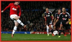 Wayne Rooney (left) scoring one of his two goals against Bayer Leverkusen at the Old Trafford, last night