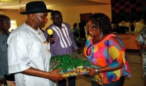 Senator Magnus Abe making a symbolic presentation of wrappers to the Leader, Andoni Legislative Assembly, Hon. Charity Wellington during a visit to the area recently. Photo: NAN