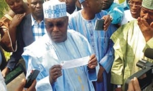 Former Vice President, Alhaji Atiku Abubakar, displaying his registration card shortly after registering as a member of All Progressives Congress (apc) in Jada town, Jada Local Government Area of Adamawa State last Wednesday. Photo: NAN