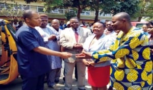 Akwa Ibom Commissioner for Health, Dr Ememabasi Bassey (left), presenting keys of a tricycle  to a focal person of the World Bank malarial control programme, Mr Monday Ikon in Uyo, recently. Photo:NAN