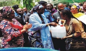 Minister of State for Agriculture, Mrs Asabe Ahmed (middle) presenting starter packs to Mrs Martha Daos, one of the beneficiaries of the packs  for  aquaculture and poultry production after their training in Abuja, yesterday.  With them is Permanent Secretary, Mrs Ibukun Odusote (left).