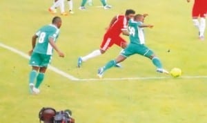 Super Eagles player trying to beat an opponent during World Cup qualifiers in Calabar, Cross River State, recently