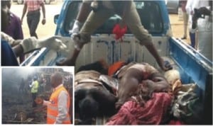 Picture shows volunteers picking up some of the dead victims of the Jos blast into a van after the explosions yesterday while (inset) is a scene of one of the bomb blasts