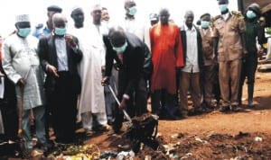 Plateau State Commissioner for Environment, Mr Silvanus Dangote, clearing refuse during the launching of public health enlightenment and sanitation in Jos, recently. Photo: NAN