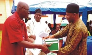  Representative of  Plateau State Commissioner for Health, Mr Ezekiel Afom (Right), presenting hospital equipment to Director, Primary Health Care, Bassa Local Government Area of Plateau, Mr Benedict Auta, during the distribution of  hospital equipment to Local Government Areas and communities under the MDGs  intervention in Jos, recently. With them is Coordinator, Millennium Development Goals (MDGs) Plateau State, Mr Peter Gai. 