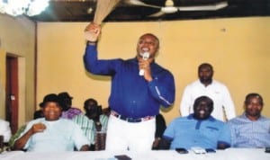 Rivers State Commissioner for Commerce and Industry, Barrister Chinye Chuma (standing), making a speech, during a congress of Non-Indigenes Political Forum in APC, Rivers State chapter in Port Harcourt  last  Wednesday.  With him are  State Co-ordinator of the forum, Chief  Uchenna  Okokoba (2nd right) and Chief  Williams Ubaka (left). 