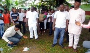 A PDP decampee to All Progressives  Congress (APC), Mr Hart Lawson Atemie (left), destroying his PDP membership card in Port Harcourt, yesterday