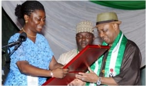 A youth leader, Mosunmola Umoru (left), presenting an award to Vice President, Namadi Sambo, at the 2014 International Youth Day celebration in Abuja, yesterday