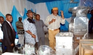 Rivers State Deputy  Governor, Engr. Tele Ikuru (centre) listens as Commissioner for Commerce and Industry, Barr. Chuma Chinye, explains functions of some equipment for distribution to beneficiaries