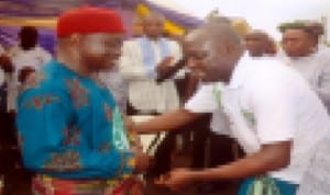 Youth President of Kpean Association, Mr. Petaba Donalolson (right) decorating Menebua Kenwigbana III, HRH Mene Barile D. Yornah with wrapper during the funeral service in honour of Late Elder Ezekiel Deebom Yornah, recently. Photo: Chris Monyanaga