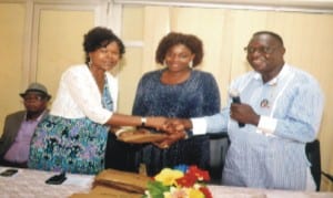 Commissioner for Social Welfare and Rehabiliation Hon. Joe Poroma (right) presenting a gift to the former Permanent Secretary of the Ministry, Dr. Mrs Stella Tony (left), Permanent Secretary of the Ministry Ms Kadilo Brown (middle) look on during the sendforth of the Retirees of the Ministry last Friday. Photo: Chris Monyanaga