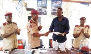 FRSC Anambra State Sector Commander, Mr Sunday Ajayi (middle), presenting safety tip materials to the Chief Executive Officer, Trigpoint Hotels, Chief Felix Ogbuefi (right), in Awka last Thursday. With them are the Head, Training Department, Mr Olusegun Akinola (left) and Head, Public Education, Mrs Chinelo Ezekwesili.        Photo: NAN