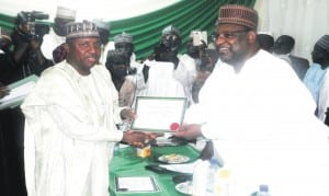 Adamawa State Governor-elect, Senator Bindow Jibrilla (left), being presented with Certificate of Return by the National Commissioner of INEC in charge of Adamawa, Gombe and Taraba States, Dr Nuru Yakubu, during the presentation ceremony in Yola last Saturday.                        					       Photo: NAN