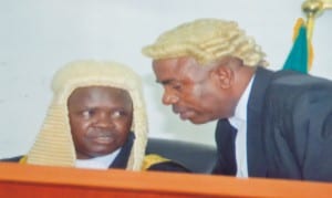 Newly sworn-in Speaker of the 8th  Rivers State House of Assembly, Rt Hon. Ikumyo Ibani (left) listening to the Acting Clerk of the House, Mr Lekie Dumnu (right) during the first sitting of the 8th Assembly last  Monday.                            					       Photo: Chris Monyanaga