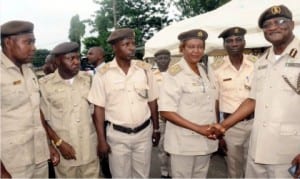 Oyo State Controller of Nigeria Immigration, Mr Innocent Akatu (right) congratulating the Chief Superintendent of Immigration, Mrs Toyin Bade-Suarau after her decoration in Ibadan yesterday. With them are other newly promoted and decorated officers.