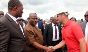 : Governor Nyesom Wike of Rivers State (2nd left), exchanging pleasantries with the Project Manager of Abonnema-Obonoma Bridge, Engr. Fadeen (right) while the CTC Chairman, Akuku-Toru LGA, Hon. Odimabo (left), watches, during the inspection of Abonnema-Obonoma bridge, by the governor, yesterday. 