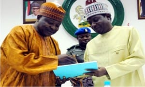 Chairman, Transition Committee, Prof. Sonni Tyoden (left), presenting the committee's report to Governor Simon Lalong of Plateau State, in Jos on Wednesday (12/8/15).       Photo: NAN