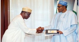 President Muhammadu Buhari (right), receiving a document from the Director-General, National Boundary Commission, Dr  Mohammed Ahmad, during a meeting at the Presidential Villa in Abuja on Thursday.