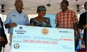   Chief Marketing Officer, Dangote Group, Mr Oare Ojeikere (left), beneficiary, Mrs Ebiokpo Endurance (middle) and South-South Zonal Cordinator, Prince Chinonye Ikegwuraka with the cheque,during a mega million promo in Port Harcourt, recently.                                                                                             Photo: Nwiveh Donatus Ken