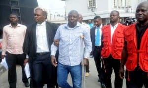 Former Director-General, Nigerian Maritime Administration and Safety Agency (NIMASA), Mr Patrick Akpobolokemi (middle), being assisted by one of hiscounsels, at the Federal High Court in Ikoyi, where he was arraigned by EFCC for alleged fraud and money laundering, in Lagos yesterday.