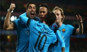 Lionel Messi and his team mates celebrating his first goal yesterday against Arsenal  during the Champions League match. Barca won by 2-0