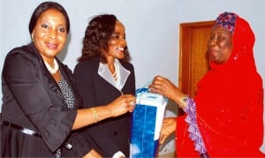 Representative of the Acting Managing Director, News Agency of Nigeria (nan), Hajiya Kahdijat Lawal (right), presenting a souvenir to  the  National Publicity Secretary, International Federation of  Women Lawyers (fida), Princess Frank-Chukwani (left) and the fida National Secretary, Mrs Rhoda Tyoden-Moore, during the visit of fida delegation to nan headquarters in Abuja, recently.