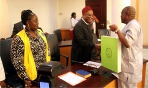  Rivers State Governor,  Chief Nyesom Wike (right), presenting a souvenir to Chairman, Senate Committee on Niger Delta, Senator Peter Nwaoboshi (middle), during a courtesy call by the Senate Committee on Niger Delta to the  Governor at Government House, Port Harcourt on Wednesday. With them is Acting Managing Director  NDDC, Mrs Ibim Semenitari 