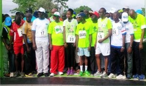 Governor Adams Oshiomhole of Edo (6th-right), Miss Nigeria, Leesi Peter-Vigoro (6th-left) and other officials at the v.i.p starting point of the 2016 Okpekpe 10km race in Edo on Saturday