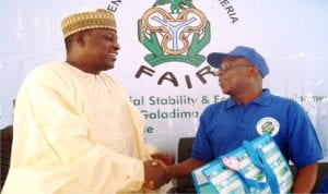 Representative of Cbn  Governor,  Alhaji Aliyu-Katuka (right), presenting a gift to representative of Adamawa State Governor, Alhaji Mahmud Sali,  during a two-day sensitisation programmes on Apex Bank initiatives in Yola on Monday.