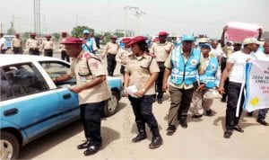 Unit Commander of Rs5.31 Onitsha Unit Command, Mr Paulinus Akpotobo (left)  and other Frsc personnel, during the 2016 West African Road Safety Organization Day campaign in Onitsha on Tuesday 