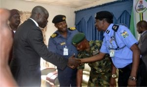  Rivers State Commissioner of Police, Mr Musa Kimo (right), welcoming the State Commissioner for Chieftaincy and Community Affairs, Hon. John Bazia (2nd left), to the Town Hall meeting on Security Challenges organised by the Commissioner of Police at Police Officers Mess, Port Harcourt, yesterday. With them are Service Chiefs.          Pix: Nuieh Donatus Ken