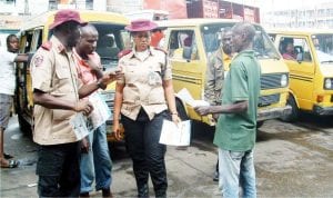 Surulere Unit Commander of the Federal Road Safety Corps, Mr Tunji Oguntonye (left), discusing with commercial bus drivers on the need to obey speed limit at Ojuelegba, during the West African Safety Organisation Day celebration in Lagos, recently.